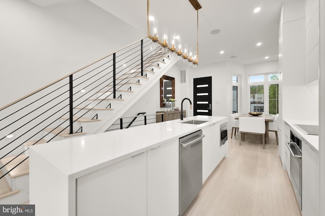 146 S St NW Unit B, Washington, DC 20001 - kitchen with modern cabinets, appliances with stainless steel finishes, white cabinets, recessed lighting, and light wood-type flooring