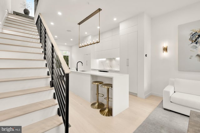 146 S St NW Unit B, Washington, DC 20001 - kitchen featuring modern cabinets, light wood finished floors, white cabinetry, recessed lighting, and light countertops