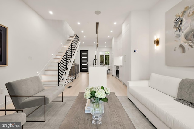 146 S St NW Unit B, Washington, DC 20001 - living area featuring light wood-type flooring, stairway, and recessed lighting