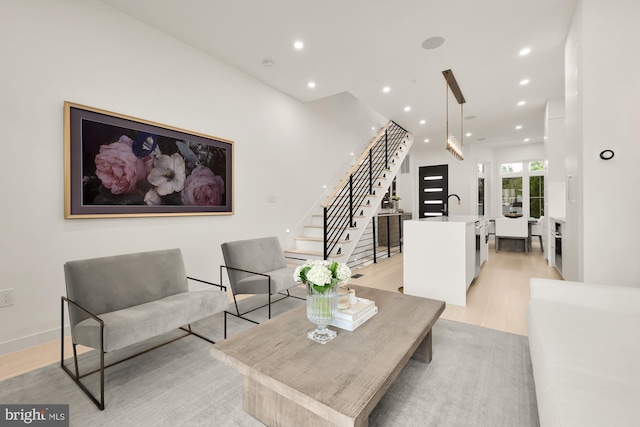 146 S St NW Unit B, Washington, DC 20001 - living room with light wood-style flooring, stairway, and recessed lighting
