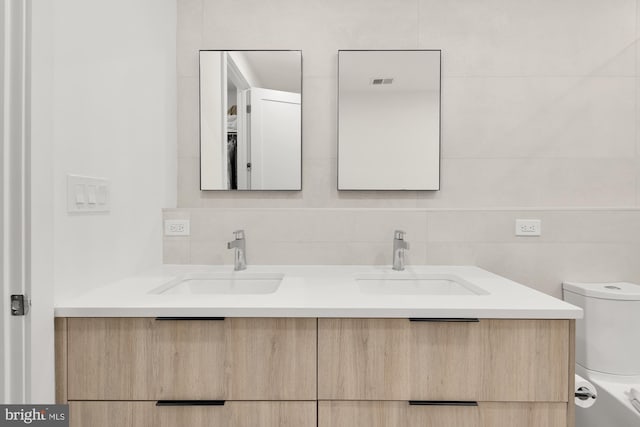 146 S St NW Unit B, Washington, DC 20001 - bathroom featuring double vanity and decorative backsplash