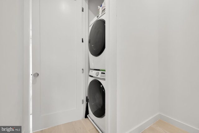 146 S St NW Unit B, Washington, DC 20001 - washroom with stacked washing machine and dryer and light wood-type flooring