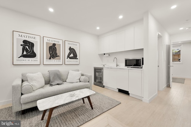 146 S St NW Unit B, Washington, DC 20001 - living area featuring wine cooler, light wood-type flooring, recessed lighting, and wet bar
