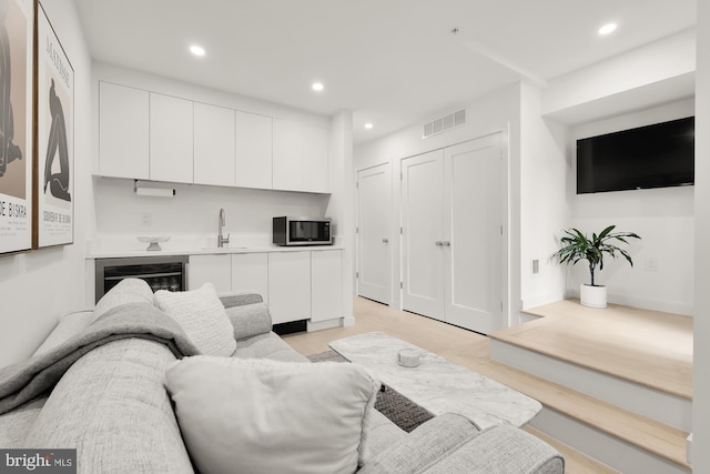 146 S St NW Unit B, Washington, DC 20001 - living room with wine cooler, recessed lighting, and light wood finished floors