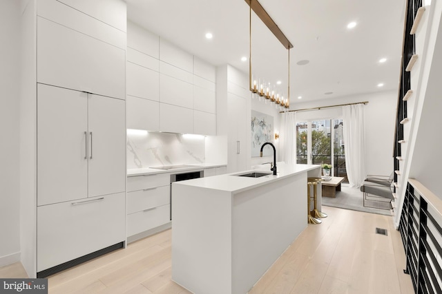 146 S St NW Unit B, Washington, DC 20001 - kitchen featuring modern cabinets, light wood-type flooring, white cabinets, a kitchen island with sink, and light countertops