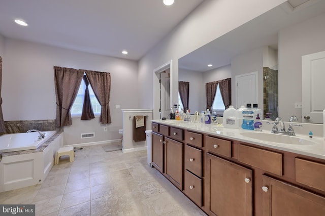 36 Elm Ct, Lancaster, PA 17603 - full bathroom featuring double vanity, a garden tub, a tile shower, recessed lighting, and a fireplace
