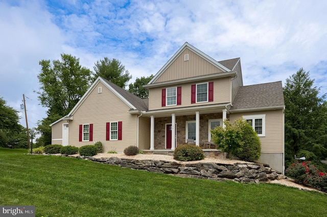36 Elm Ct, Lancaster, PA 17603 - view of front of property featuring covered porch, a front yard, stone siding, roof with shingles, and board and batten siding