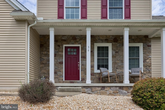 36 Elm Ct, Lancaster, PA 17603 - view of exterior entry with stone siding and a porch