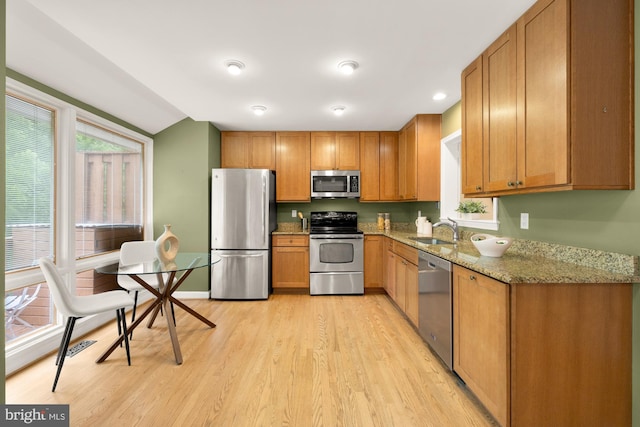 1937 Hickory Hill Ln, Silver Spring, MD 20906 - kitchen with appliances with stainless steel finishes, light wood-style floors, light stone counters, and brown cabinets