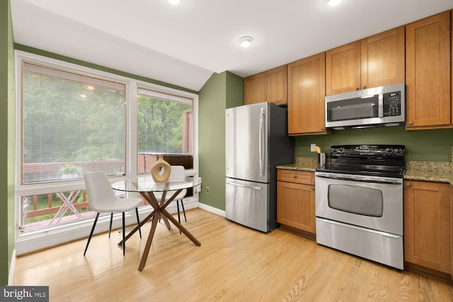 1937 Hickory Hill Ln, Silver Spring, MD 20906 - kitchen with stainless steel appliances, light wood-type flooring, brown cabinetry, and stone counters