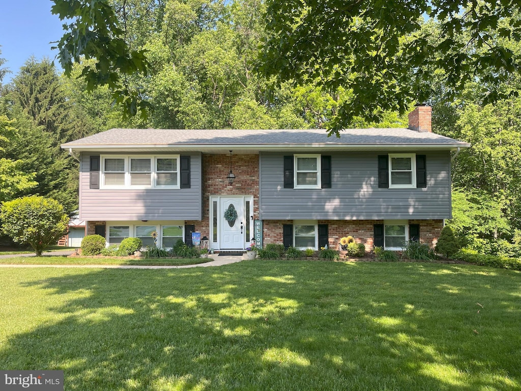 1706 Abelia Rd, Fallston, MD 21047 - bi-level home featuring a front lawn, a chimney, and brick siding