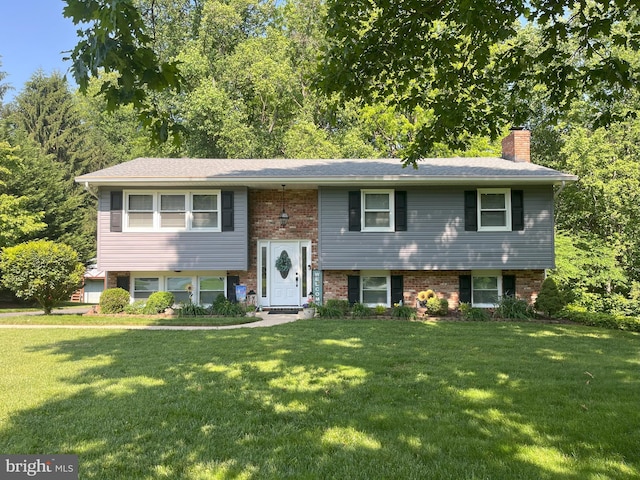 1706 Abelia Rd, Fallston, MD 21047 - bi-level home featuring a front lawn, a chimney, and brick siding