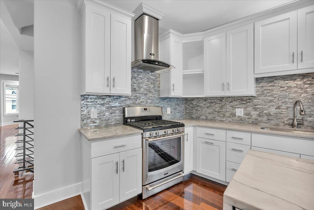 144 Levering St, Philadelphia, PA 19127 - kitchen featuring stainless steel gas range, wall chimney exhaust hood, white cabinetry, dark wood finished floors, and light stone counters