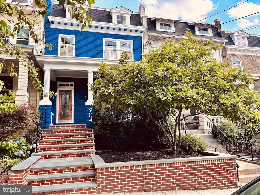 904 Emerson St NW, Washington, DC 20011 - view of front facade with mansard roof, a shingled roof, and brick siding