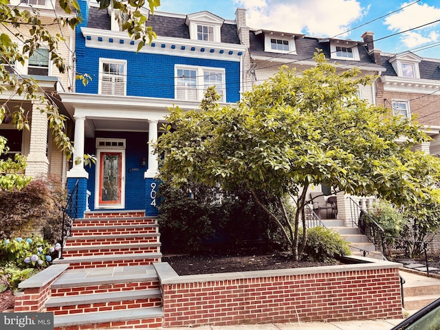 904 Emerson St NW, Washington, DC 20011 - view of front facade with mansard roof, a shingled roof, and brick siding