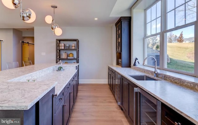 Lot1 Nathan Hale, Berwyn, PA 19312 - kitchen with beverage cooler, a barn door, light wood finished floors, decorative light fixtures, and recessed lighting