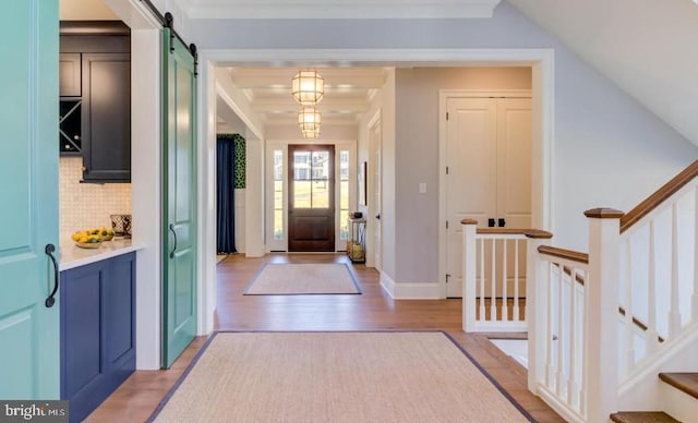 Lot1 Nathan Hale, Berwyn, PA 19312 - entryway with a barn door, light wood-type flooring, ornamental molding, and stairway