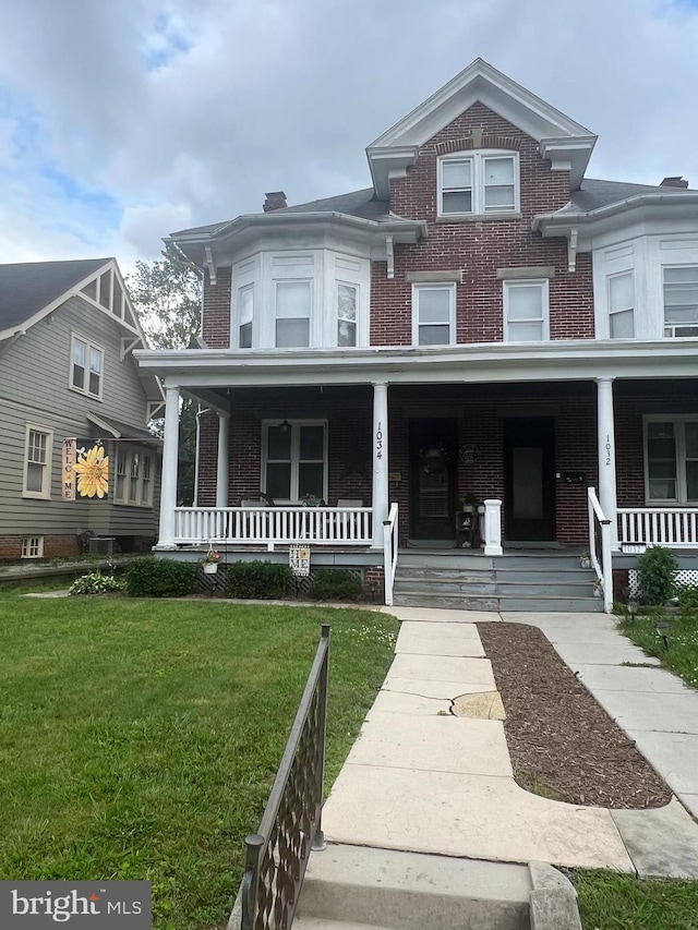 1034 Hamilton Blvd, Hagerstown, MD 21742 - view of front of home featuring brick siding, a porch, and a front yard