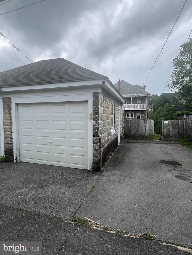 1034 Hamilton Blvd, Hagerstown, MD 21742 - view of side of property with stone siding, asphalt driveway, a garage, an outdoor structure, and roof with shingles