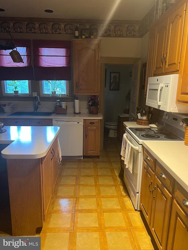 1034 Hamilton Blvd, Hagerstown, MD 21742 - kitchen with white appliances, light countertops, brown cabinetry, and light floors
