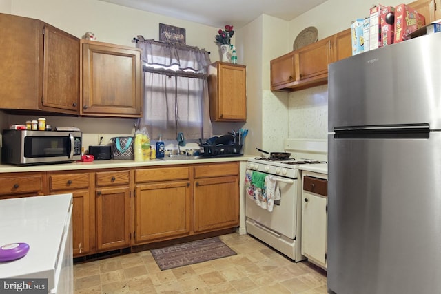 2450 N 6th St, Harrisburg, PA 17110 - kitchen with stainless steel appliances, light countertops, and brown cabinets
