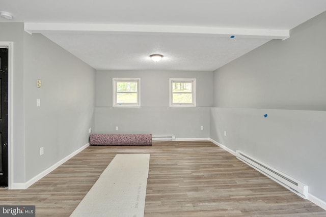 121 Almond Ct, Milford, PA 18337 - below grade area with a baseboard heating unit and light wood-style flooring