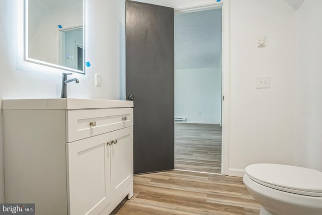 121 Almond Ct, Milford, PA 18337 - half bathroom featuring vanity, wood finished floors, and baseboard heating