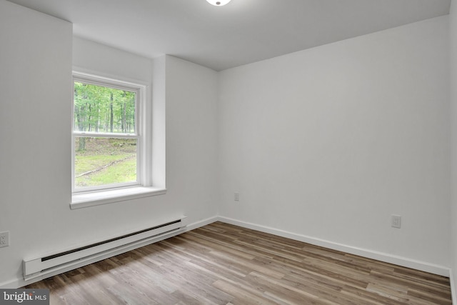 121 Almond Ct, Milford, PA 18337 - spare room with baseboard heating and wood finished floors