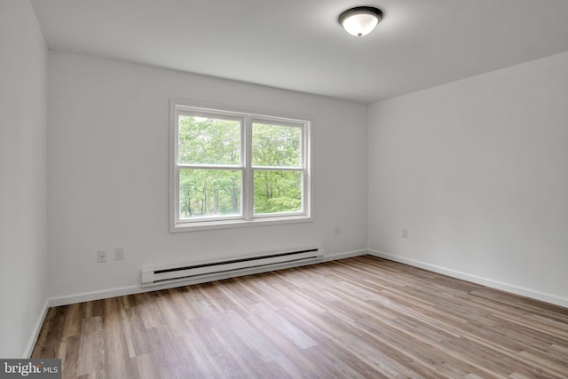 121 Almond Ct, Milford, PA 18337 - empty room featuring a baseboard radiator and wood finished floors