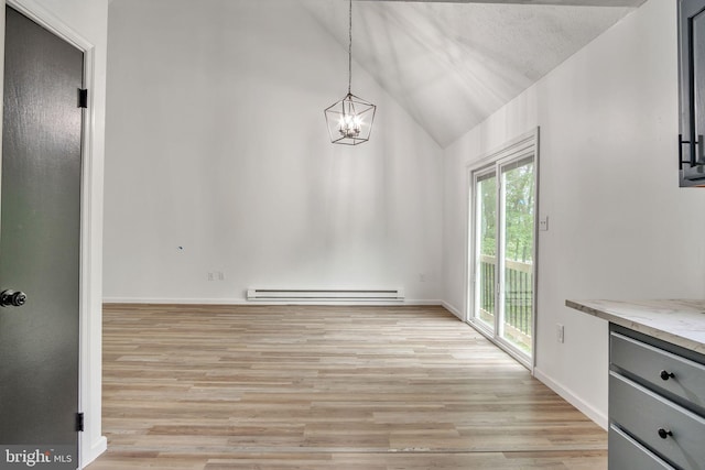 121 Almond Ct, Milford, PA 18337 - unfurnished dining area with baseboard heating, lofted ceiling, light wood-style flooring, and a chandelier