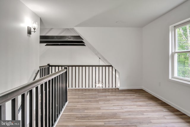 121 Almond Ct, Milford, PA 18337 - hallway with plenty of natural light, wood finished floors, and an upstairs landing
