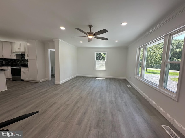 8357 Gannon Cir, Easton, MD 21601 - unfurnished living room featuring a ceiling fan, wood finished floors, recessed lighting, and crown molding
