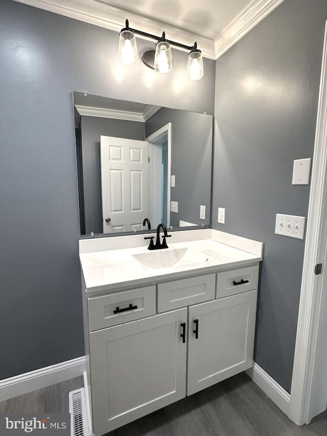 8357 Gannon Cir, Easton, MD 21601 - bathroom featuring ornamental molding, wood finished floors, and vanity