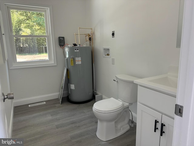 8357 Gannon Cir, Easton, MD 21601 - bathroom featuring electric water heater, vanity, and wood finished floors