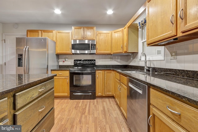 5 Michael Ct, Rehoboth Beach, DE 19971 - kitchen featuring stainless steel appliances, light wood-type flooring, tasteful backsplash, dark stone counters, and recessed lighting