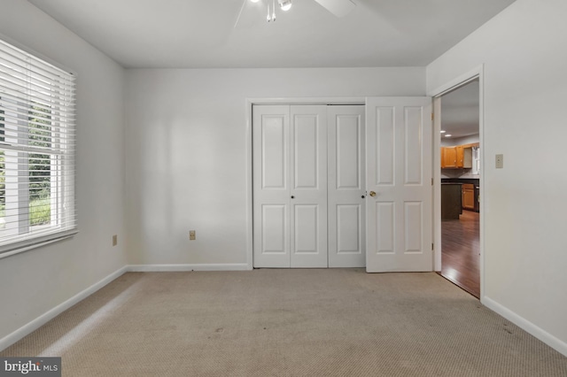 5 Michael Ct, Rehoboth Beach, DE 19971 - unfurnished bedroom with light carpet, multiple windows, a closet, and a ceiling fan