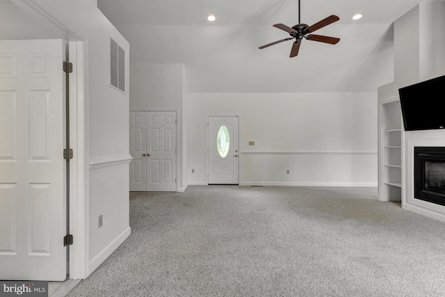 5 Michael Ct, Rehoboth Beach, DE 19971 - unfurnished living room with carpet flooring, ceiling fan, a glass covered fireplace, vaulted ceiling, and built in features
