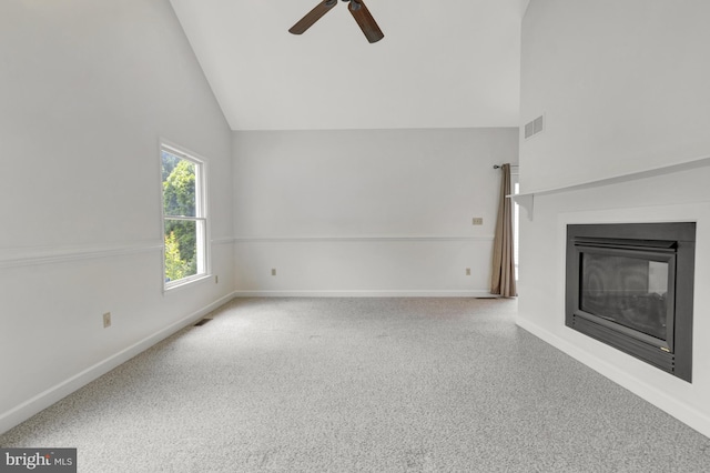 5 Michael Ct, Rehoboth Beach, DE 19971 - unfurnished living room featuring a ceiling fan, high vaulted ceiling, a glass covered fireplace, and carpet flooring