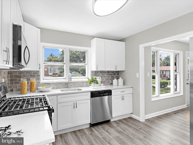 901 Vanderwood Rd, Baltimore, MD 21228 - kitchen with appliances with stainless steel finishes, light wood-style flooring, backsplash, and healthy amount of natural light