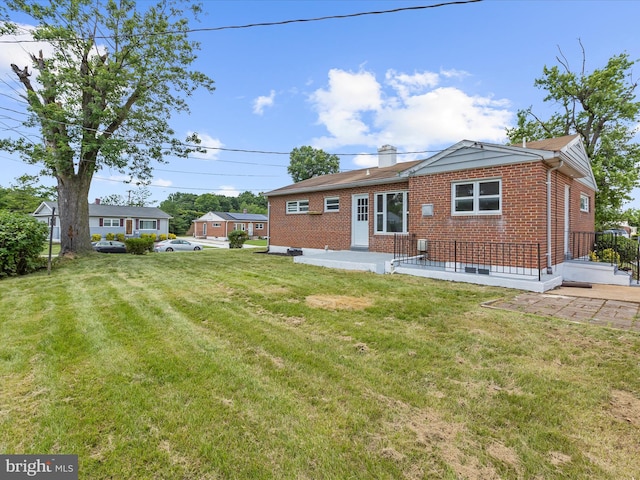 901 Vanderwood Rd, Baltimore, MD 21228 - back of house with brick siding, a lawn, and a patio