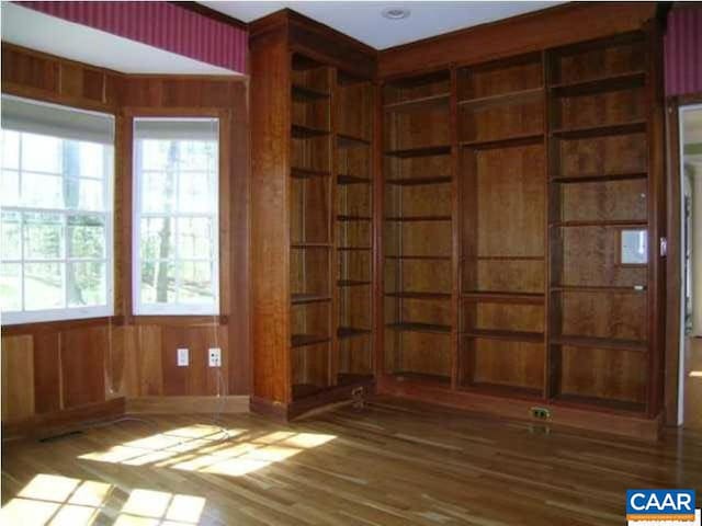 3190 Prestwick Pl, Keswick, VA 22947 - unfurnished room with wood finished floors, plenty of natural light, and wooden walls