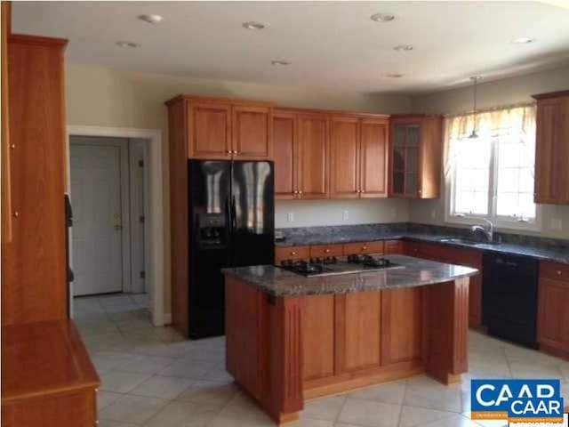 3190 Prestwick Pl, Keswick, VA 22947 - kitchen with black appliances, a center island, glass insert cabinets, dark countertops, and light tile patterned floors