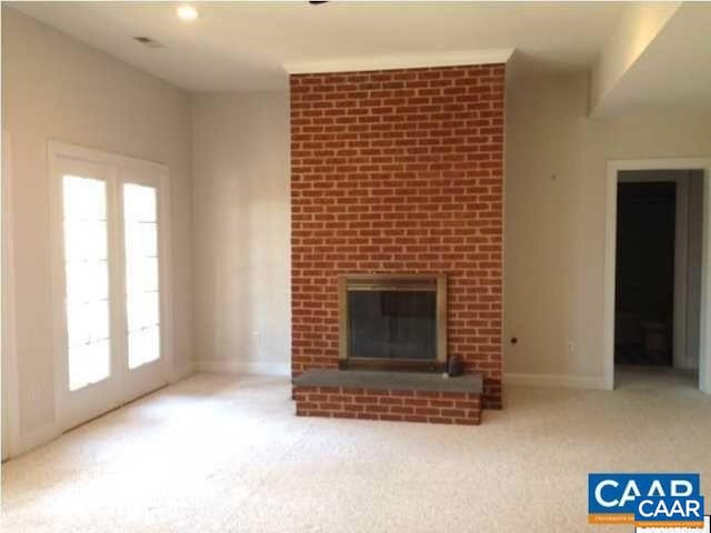 3190 Prestwick Pl, Keswick, VA 22947 - unfurnished living room with a fireplace and carpet flooring