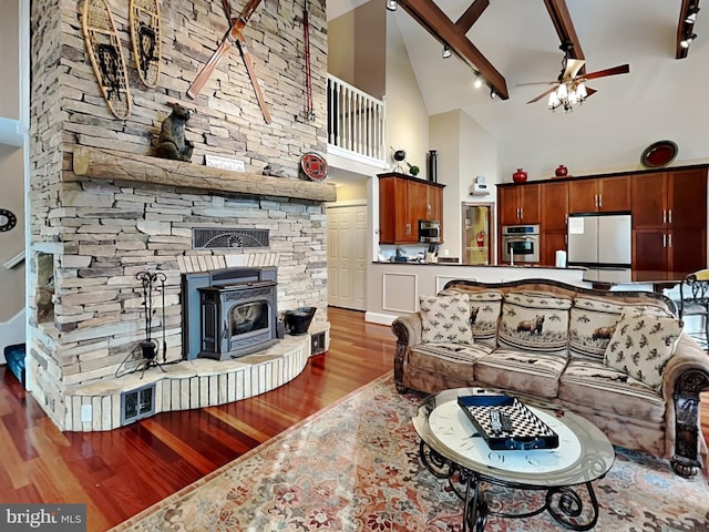 3067 Shingle Camp Rd, Mc Henry, MD 21541 - living room featuring high vaulted ceiling, wood finished floors, ceiling fan, rail lighting, and a wood stove