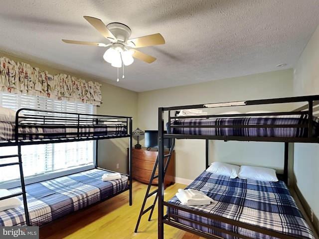 3067 Shingle Camp Rd, Mc Henry, MD 21541 - bedroom featuring wood finished floors, a textured ceiling, and a ceiling fan