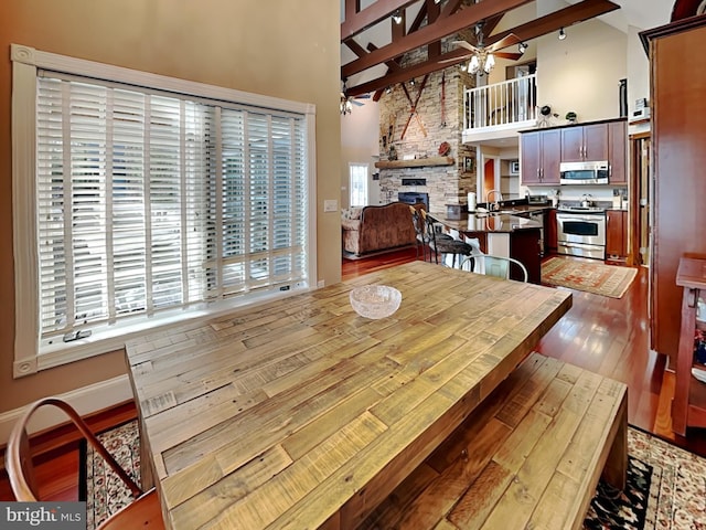 3067 Shingle Camp Rd, Mc Henry, MD 21541 - dining area featuring high vaulted ceiling, a ceiling fan, a fireplace, wood finished floors, and beam ceiling