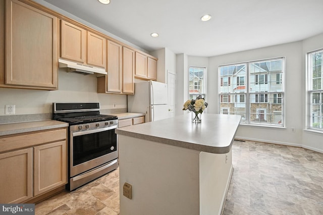 6949 Banchory Ct, Alexandria, VA 22315 - kitchen featuring stainless steel gas stove, under cabinet range hood, freestanding refrigerator, light brown cabinets, and plenty of natural light