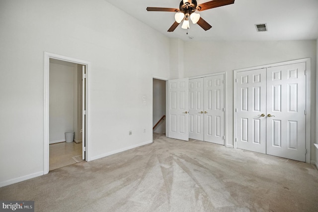 6949 Banchory Ct, Alexandria, VA 22315 - unfurnished bedroom featuring carpet floors, two closets, ensuite bathroom, high vaulted ceiling, and a ceiling fan