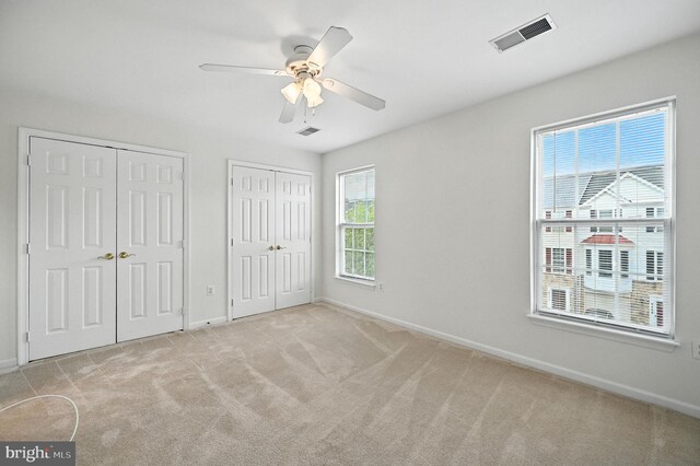6949 Banchory Ct, Alexandria, VA 22315 - unfurnished bedroom featuring two closets, carpet floors, and ceiling fan
