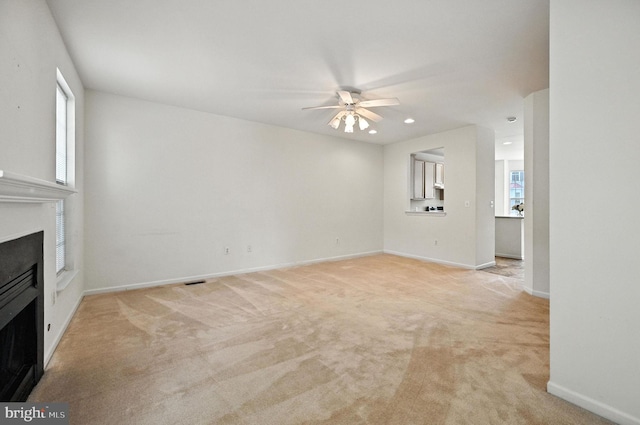 6949 Banchory Ct, Alexandria, VA 22315 - unfurnished living room featuring a fireplace, a ceiling fan, light carpet, and recessed lighting
